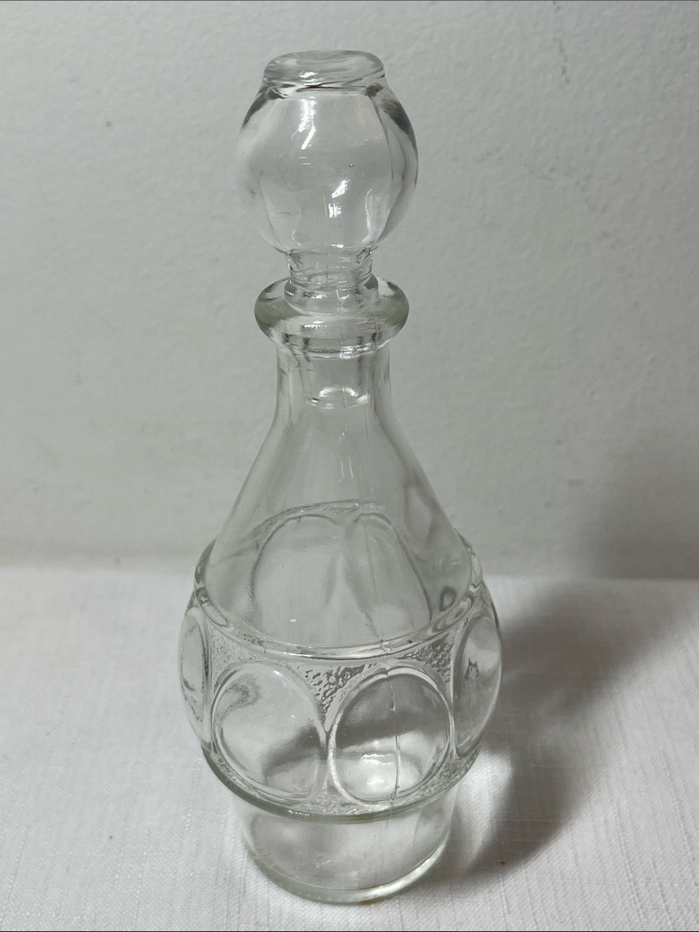 Clear vintage pressed-glass cruet or small decanter
rounded body
Glass stopper
